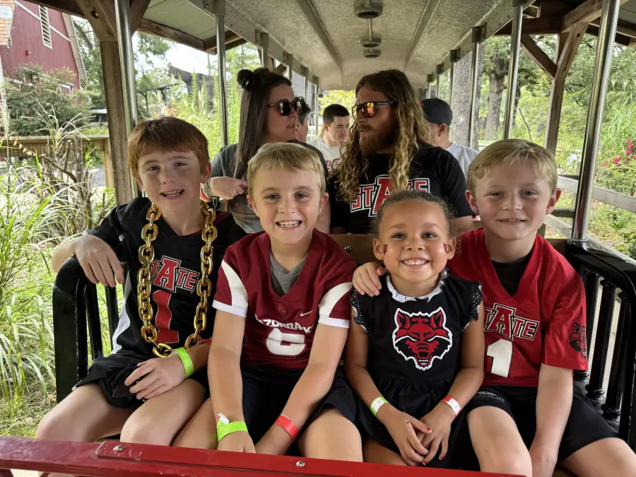 Families riding a train at the zoo